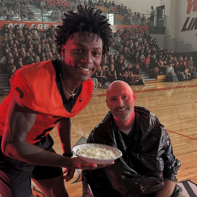student and staff member with a pie