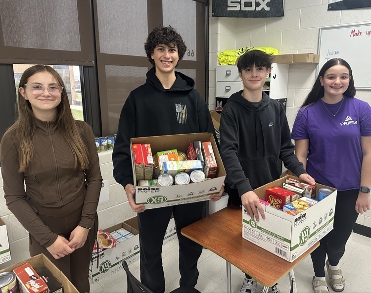 students holding boxes of food donations