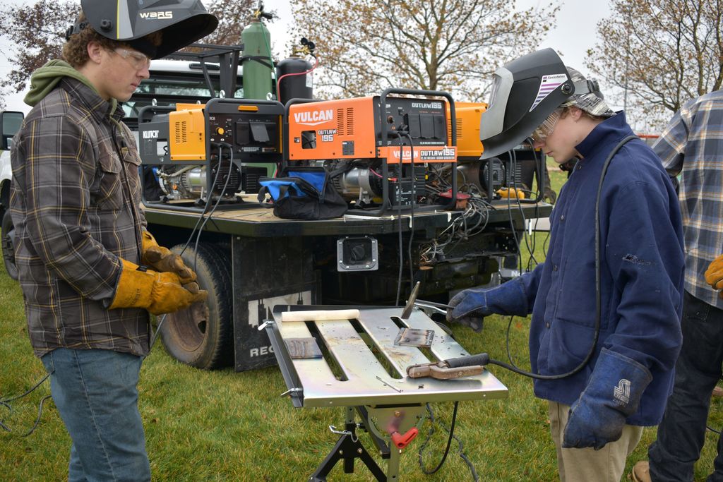 Students welding outside