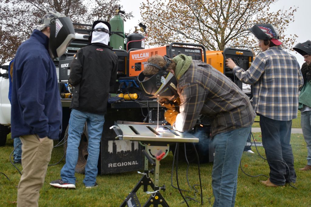 Students welding outside