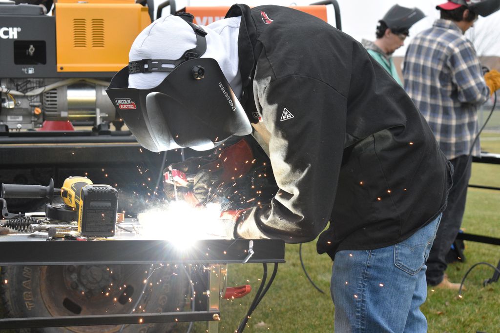 Students welding outside