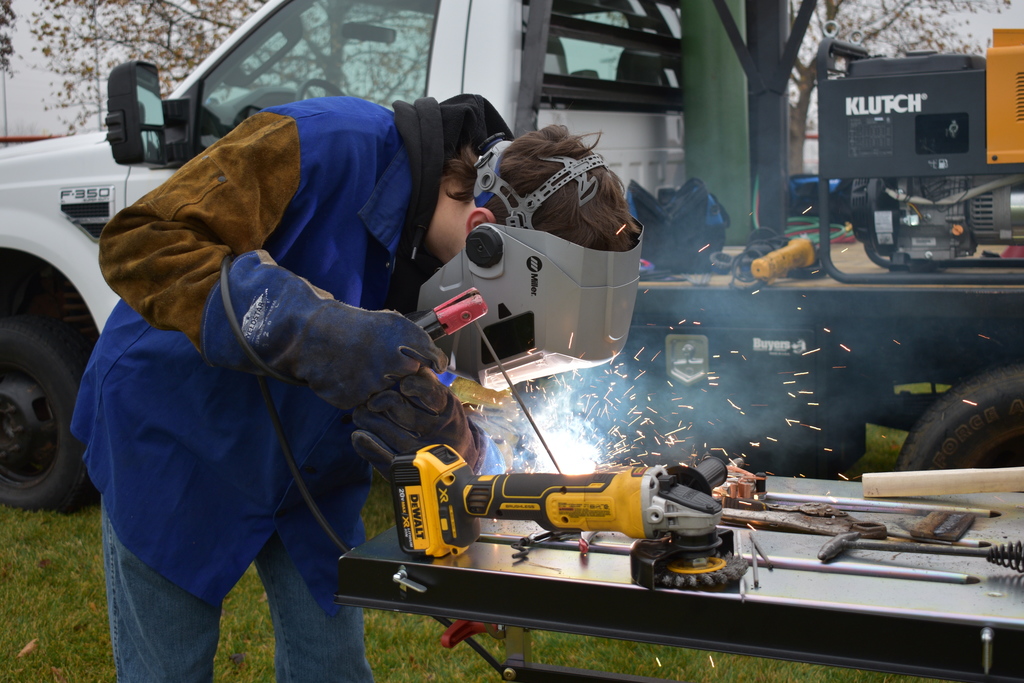 Students welding outside