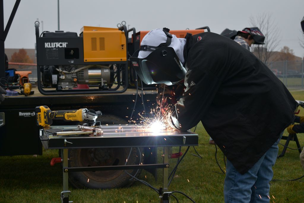 Students welding outside