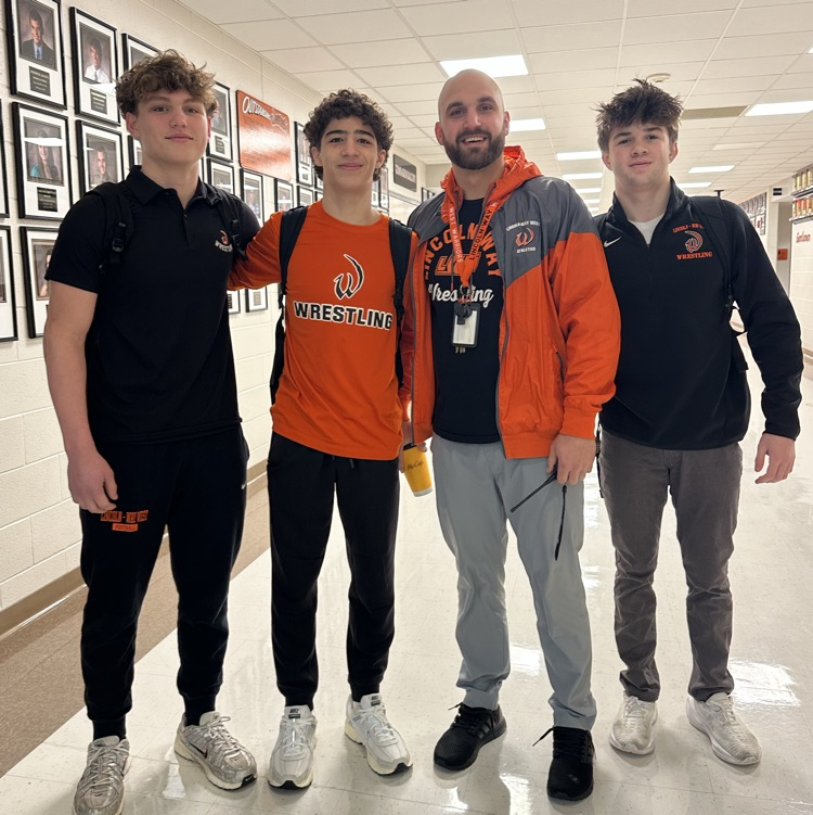 students and coach wearing orange