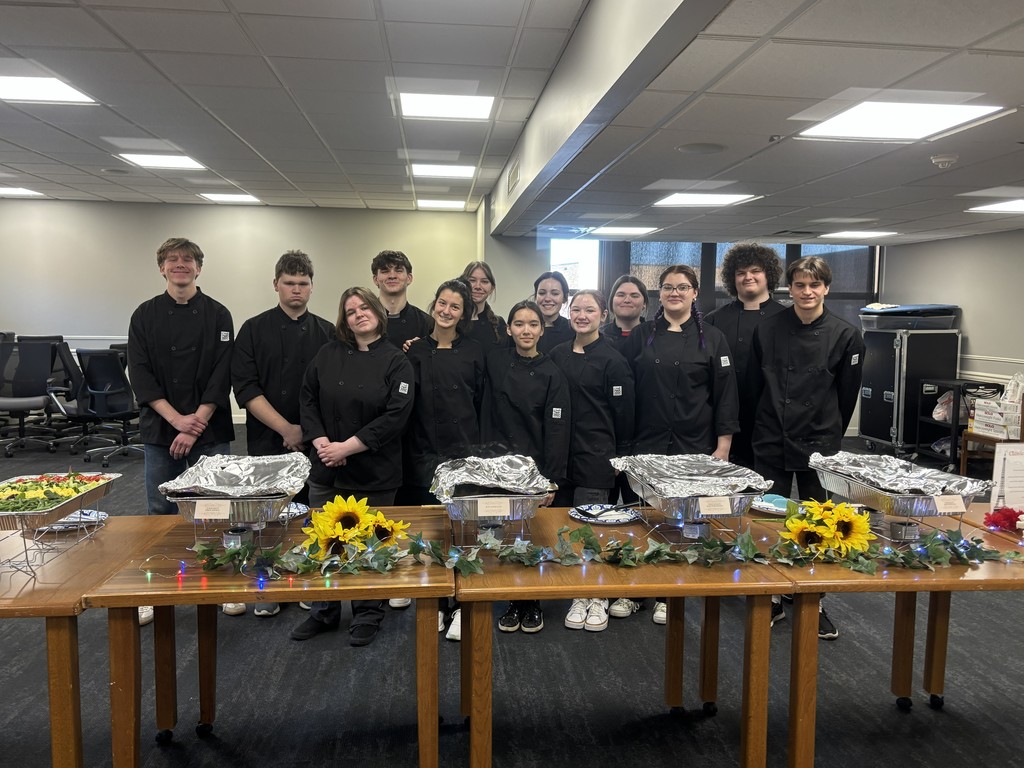 LWC Culinary students standing behind the food buffet