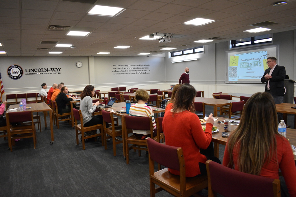 Staff sitting in a classroom listening to a presentation