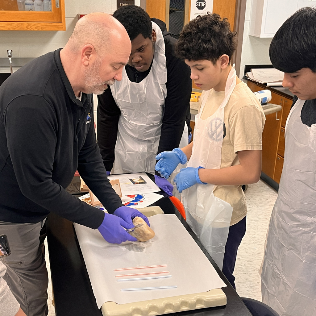 Mr. Mulconrey instructing in a science lab with students.
