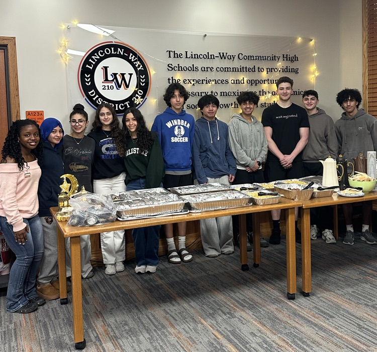 students in front of dinner table