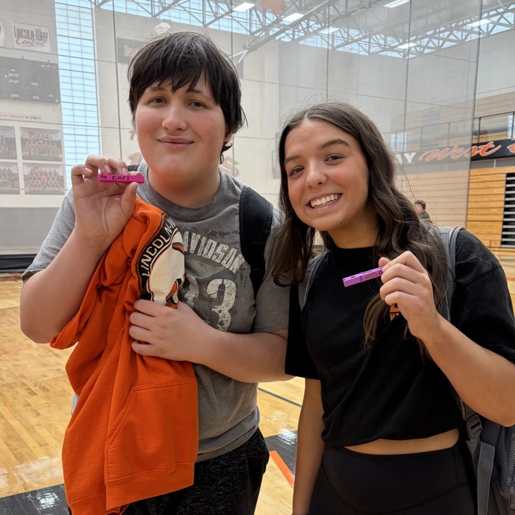two students holding kindness clip