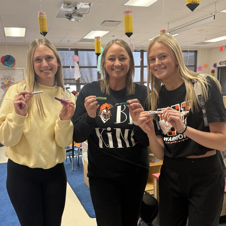 students and teacher holding kindness clips