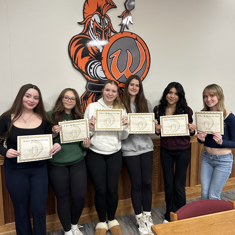 students holding certificates in front of the Warrior