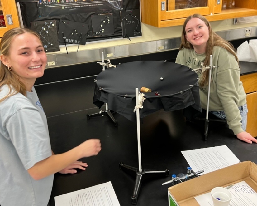 Mr. Tucker's Astronomy classes analyzed "space-time" surfaces by rolling marbles. This allowed students to see how mass warps space and how that curvature guides motion.
