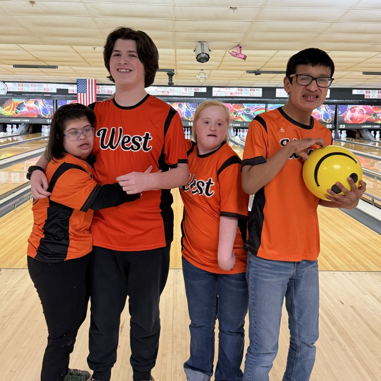 group photo in front of the bowling lanes 