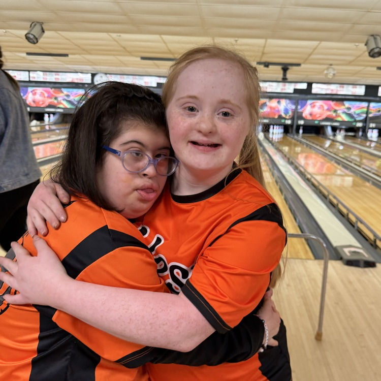 student in front of the bowling lanes