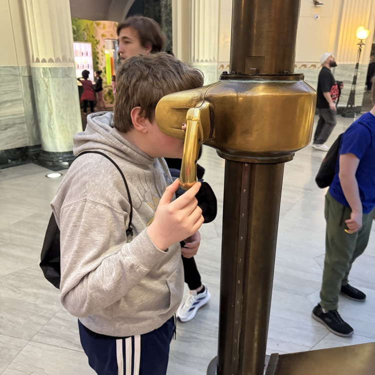 student looking through a periscope