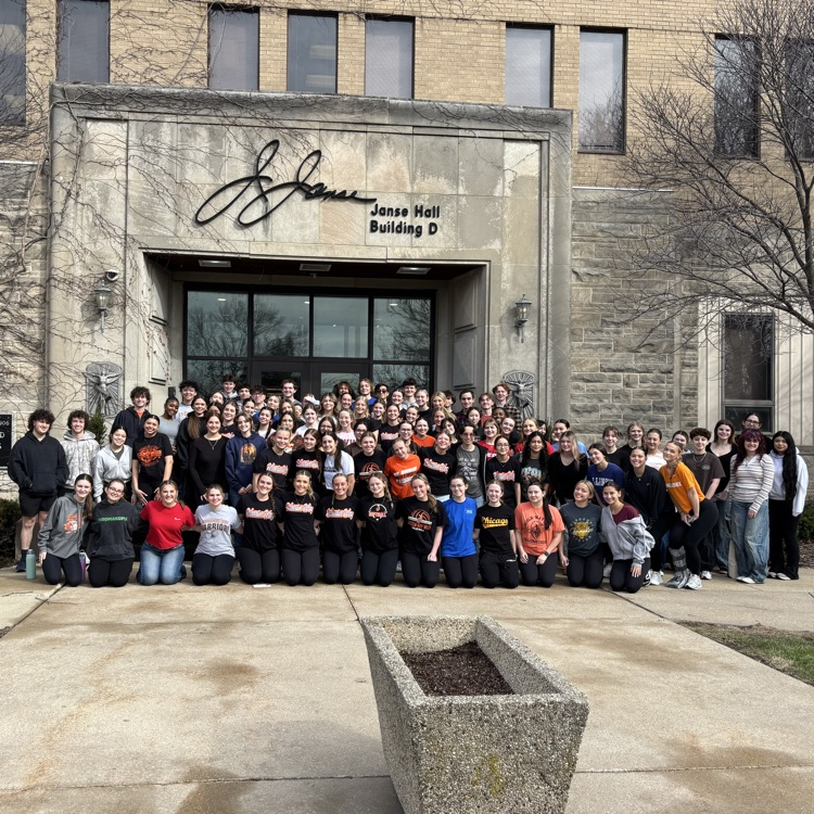 students in front of hospital building