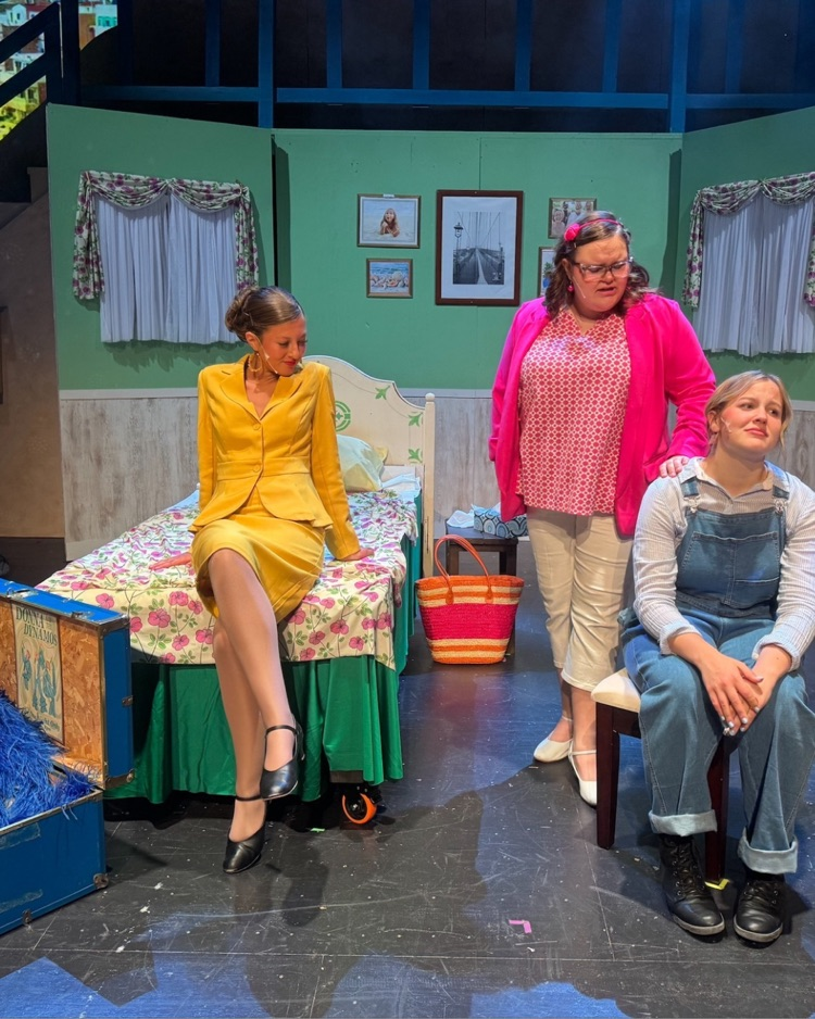 3 students on stage acting