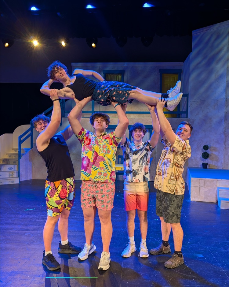 multiple students on stage after a dance performance