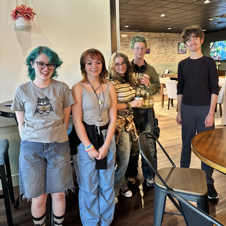 students at coffee shop for club book meeting