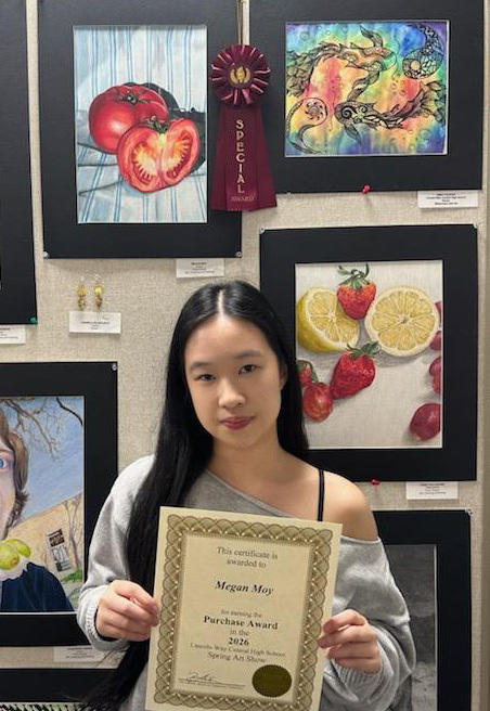 Megan Moy standing by her award winning artwork