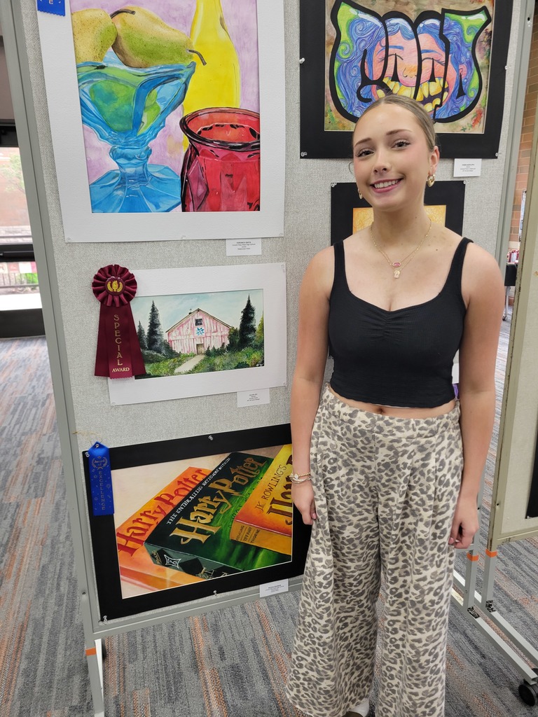 Olivia Zic standing next to her winning painting