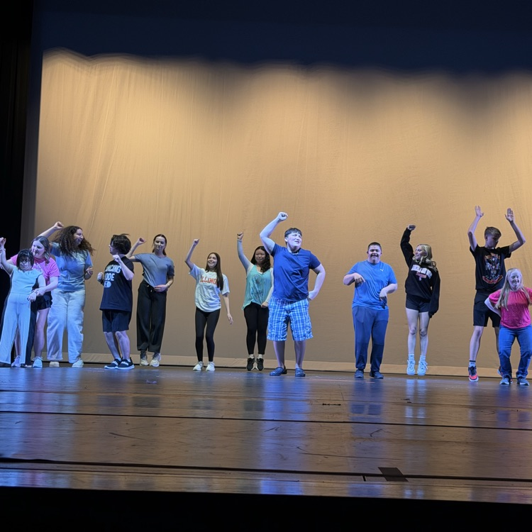 multiple students dancing on stage