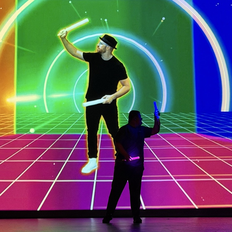 student performing a routine with video in the background