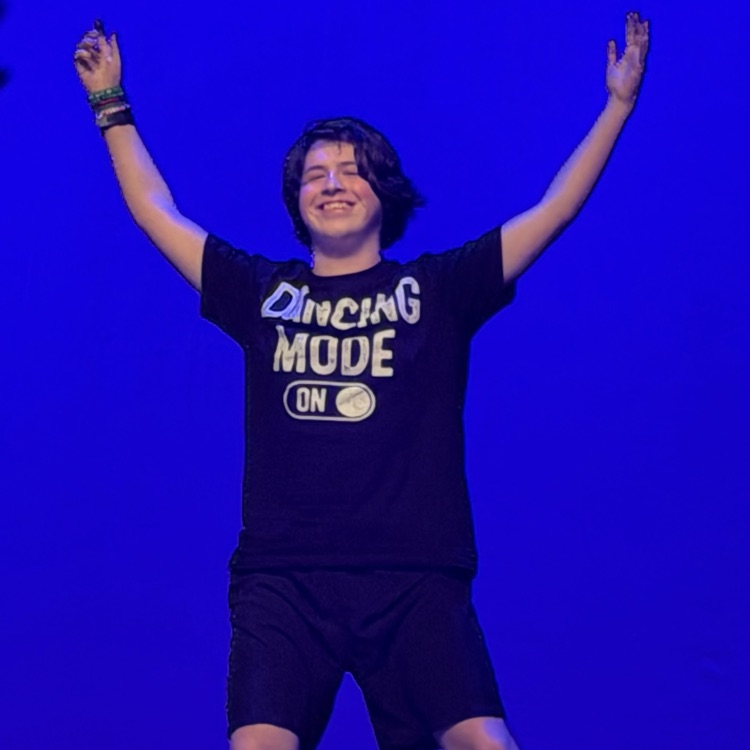 one student on stage with a blue background