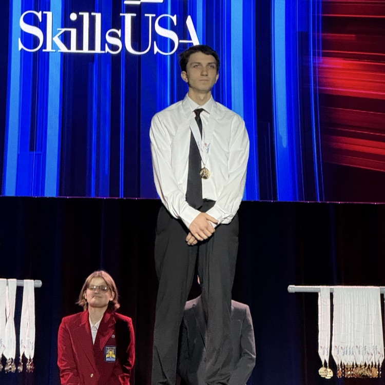 student on the SkillsUSA stage after being named the 1st place winner 