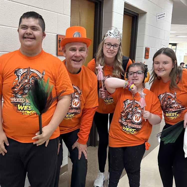 four students and staff member posing for a photo