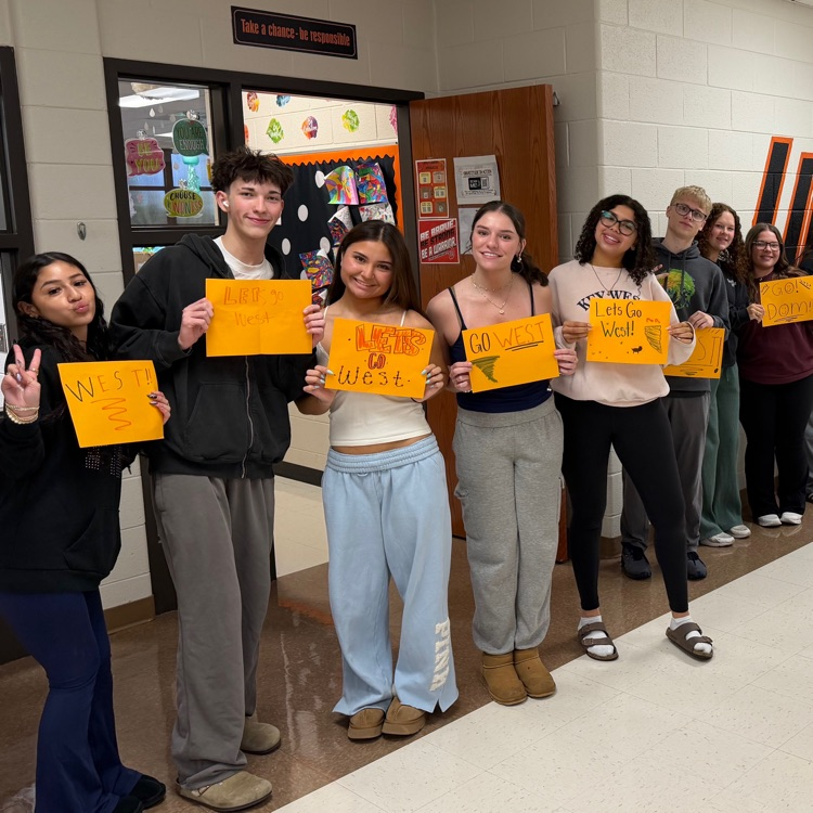 multiple students holding signs