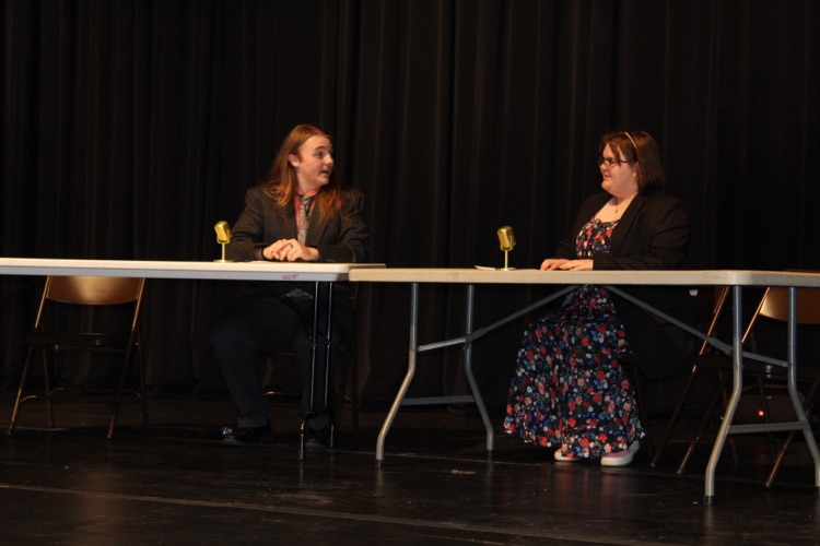 two students acting on stage