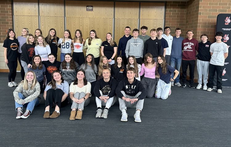group of students posing for a photo in the auditorium lobby