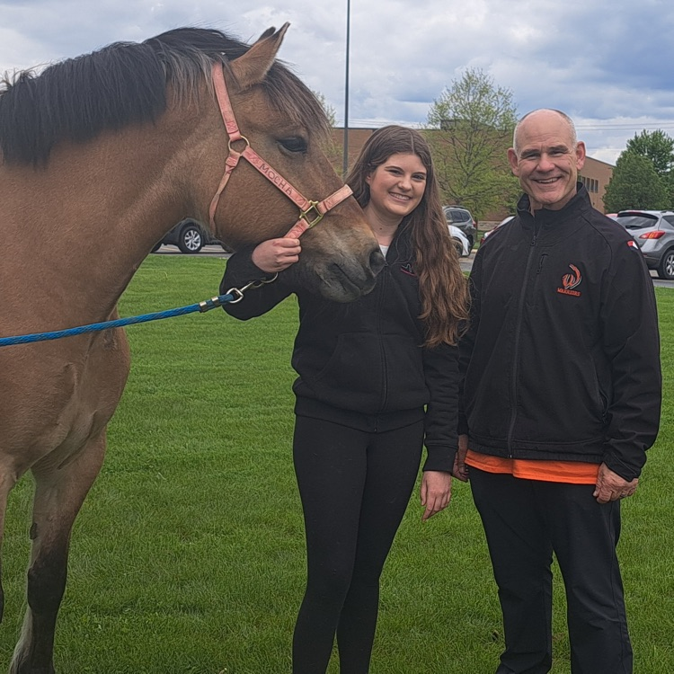 horse, student and principal posing for a photo