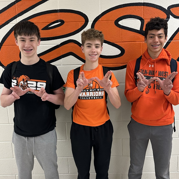 three students wearing school spirit wear
