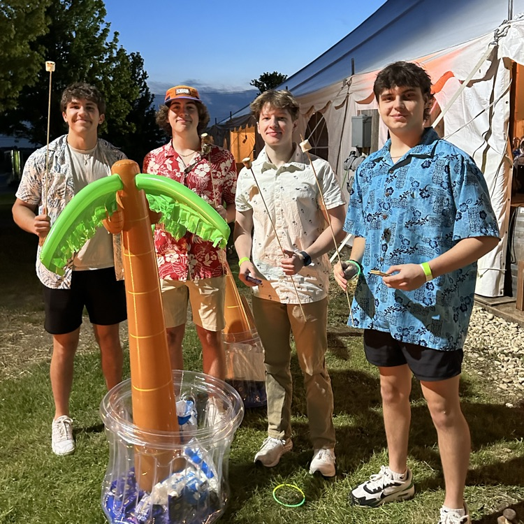 four students in Hawaiian attire at event 