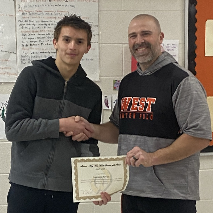 student shaking hands with the math department chair while holding a certificate