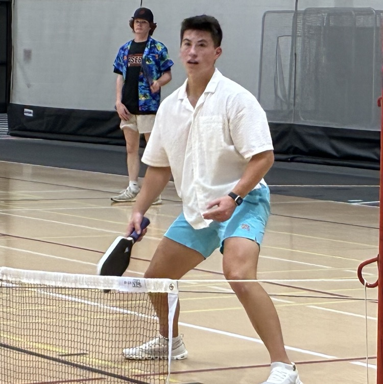 one student playing pickleball