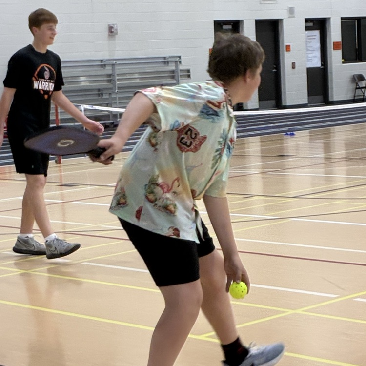 two students playing pickleball