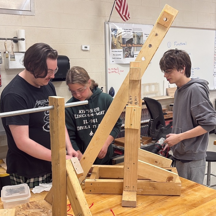 group of students working with wood for project 