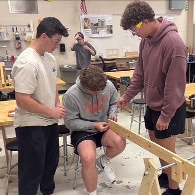 three students working on together on project 