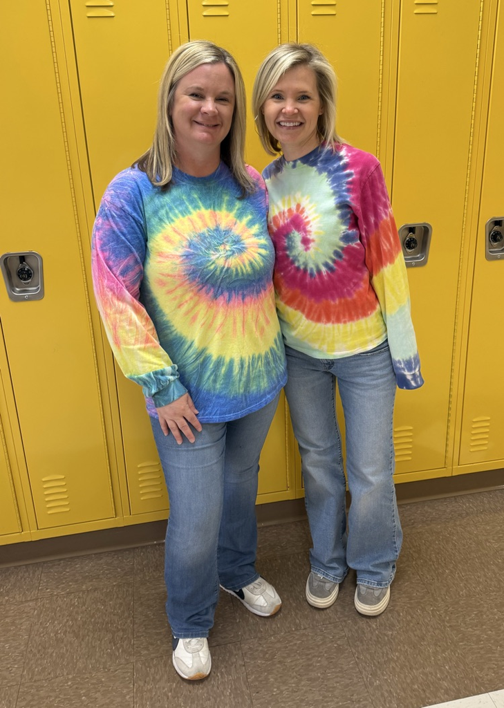 two staff wearing tie dye