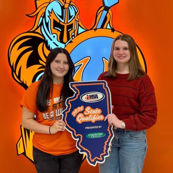 two students holding a state banner