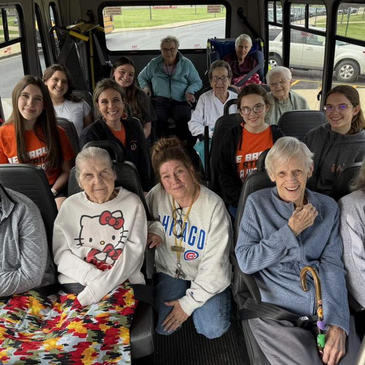 photo of residents and students on a bus together