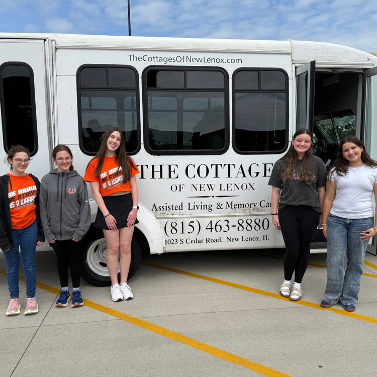 students in front of bus
