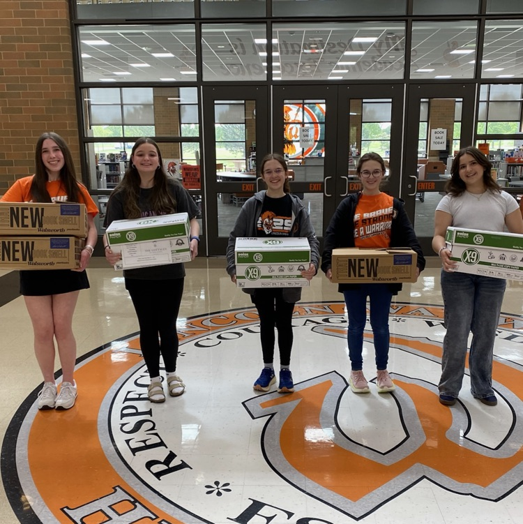 five students holding donations