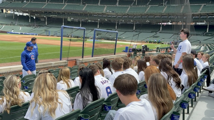 students hearing cubs player present