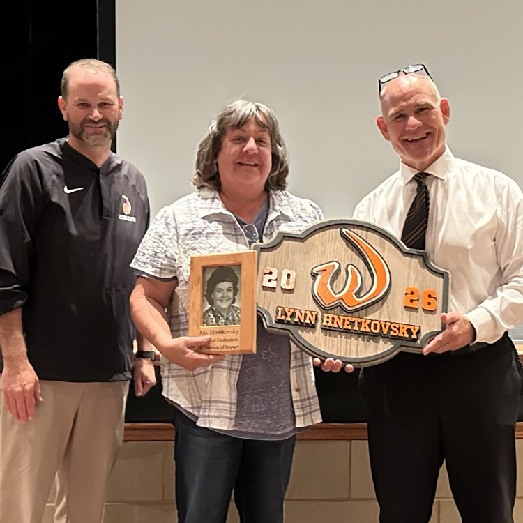 staff member with plaques