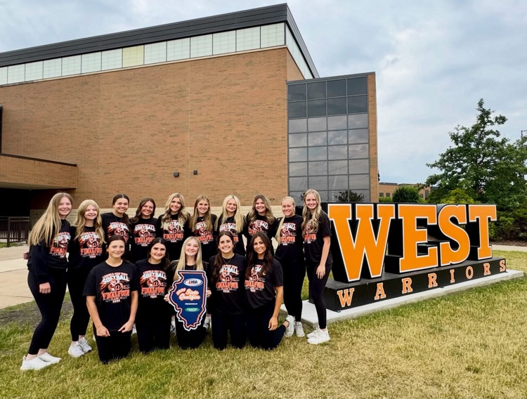 team standing in front of WEST letters