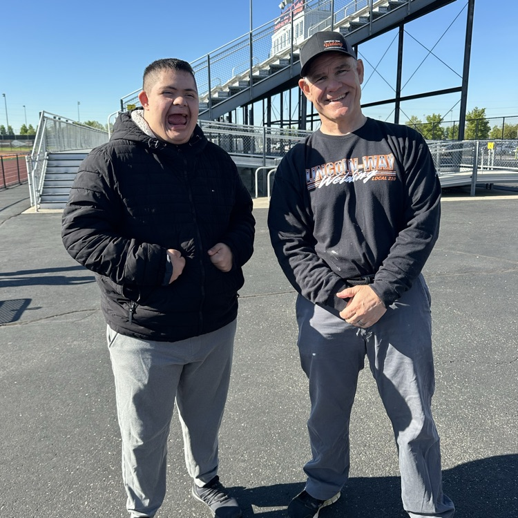 principal and student at stadium